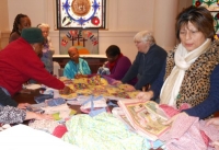 Members examining Fabric donations for Charity Quilts