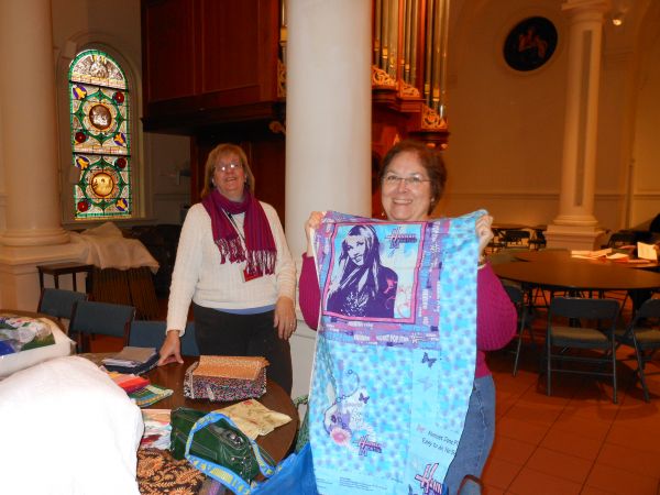 Jennifer Bigelow and Beth Pile admiring fabric donations
