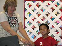 Beth Pile and Michael Fung with the Friendship Quilt